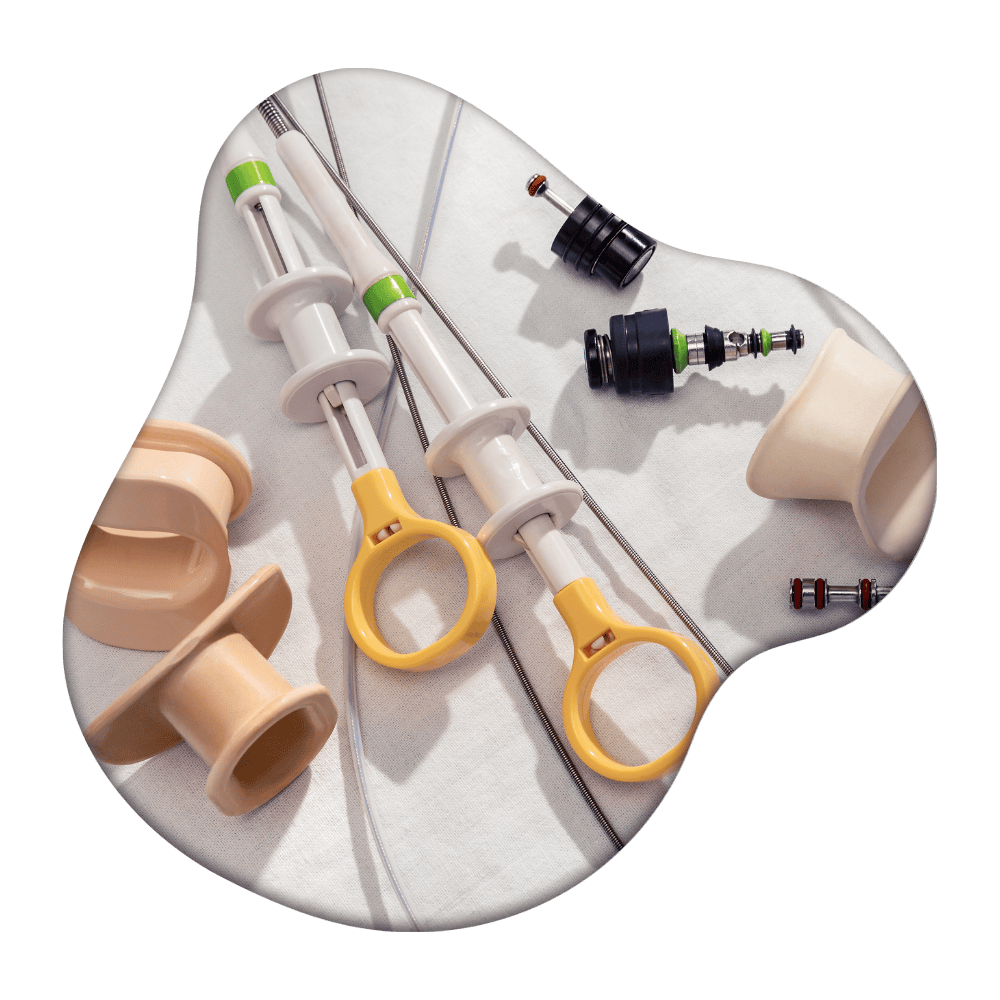 Dental implant components and surgical tools displayed on a kidney-shaped tray, including syringes, abutments, and prosthetic parts in white, beige, and yellow