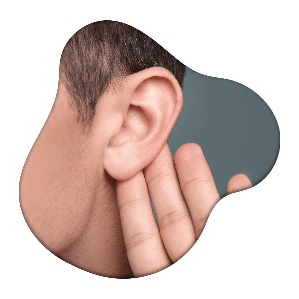 Person's head in profile with fingers touching ear against gray background